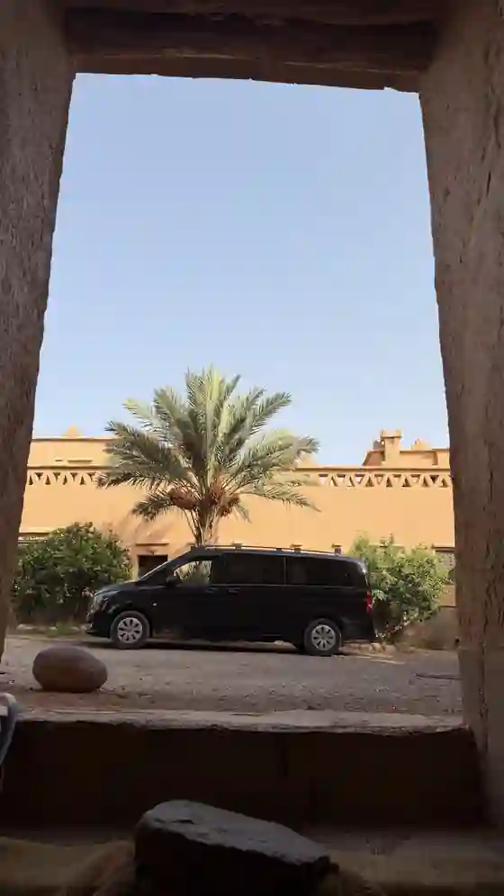 Private vehicle framed by earthen architecture in N'Kob, southern Morocco