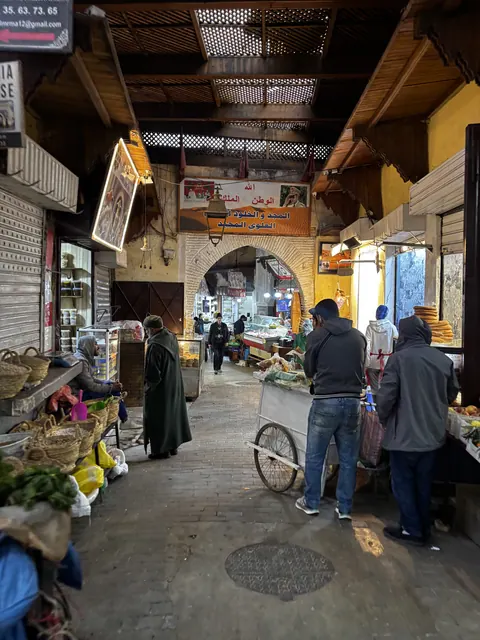 Local market lane in Morocco with people and a bicycle