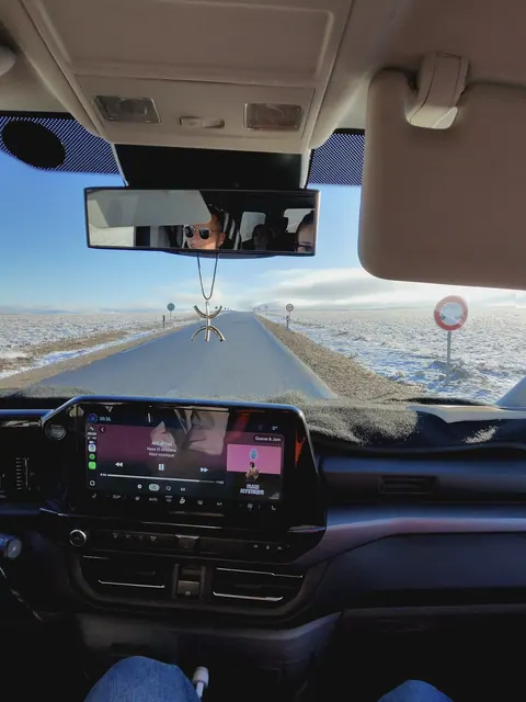 Interior vehicle view on a snowy Morocco mountain road